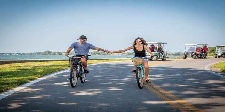 Photo of a couple riding a bike at Put-in-Bay
